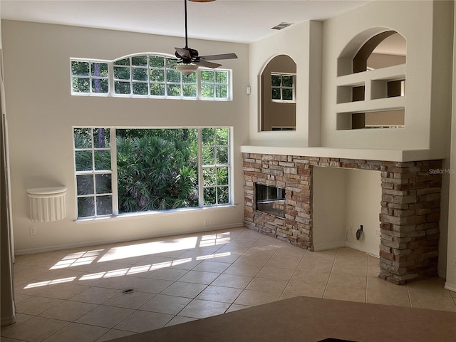 2143 Autumn View Dr, Orlando, FL 32825 - unfurnished living room featuring a ceiling fan, plenty of natural light, tile patterned flooring, and a fireplace