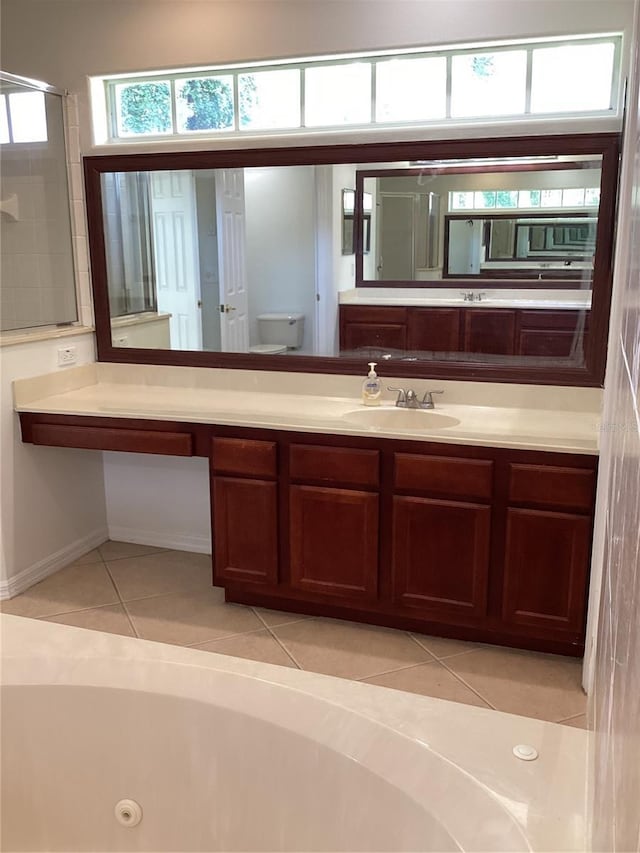 2143 Autumn View Dr, Orlando, FL 32825 - bathroom featuring tile patterned flooring, vanity, toilet, a jetted tub, and a shower with shower door