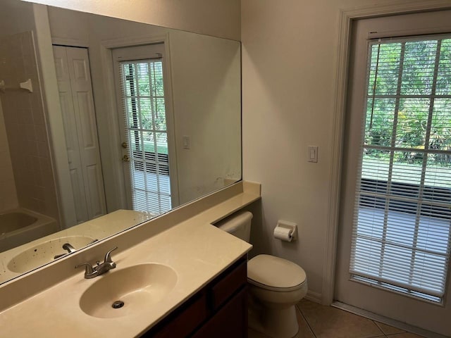 2143 Autumn View Dr, Orlando, FL 32825 - full bathroom with tile patterned floors, vanity, toilet, and plenty of natural light