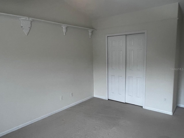 2143 Autumn View Dr, Orlando, FL 32825 - unfurnished bedroom featuring baseboards, a closet, and dark carpet