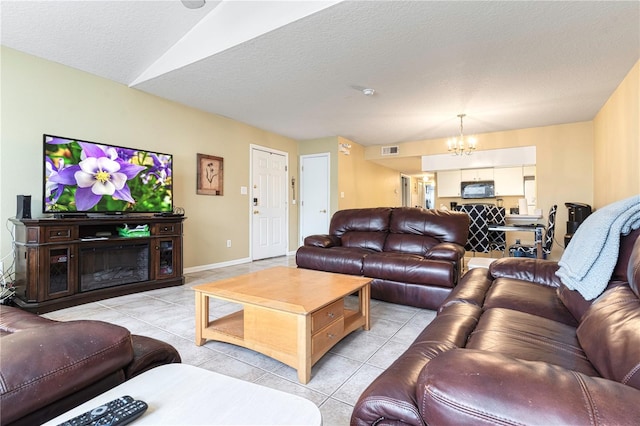 8719 Rockingham Ter Unit B, Kissimmee, FL 34747 - living area featuring a chandelier, light tile patterned floors, a textured ceiling, and baseboards
