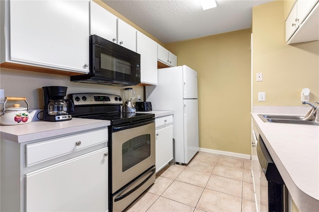 8719 Rockingham Ter Unit B, Kissimmee, FL 34747 - kitchen with stainless steel range with electric stovetop, black microwave, freestanding refrigerator, a sink, and light countertops