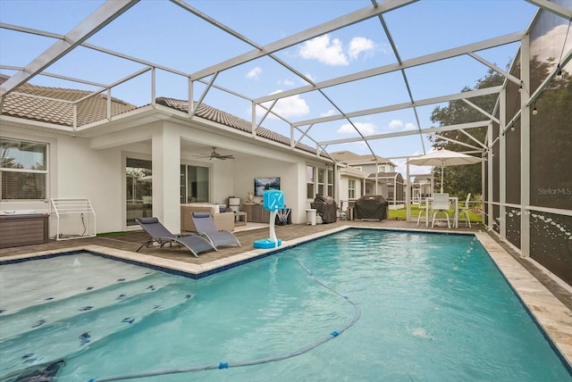 8811 Bally Neal Loop, Davenport, FL 33896 - outdoor pool with a patio area, area for grilling, a ceiling fan, and glass enclosure