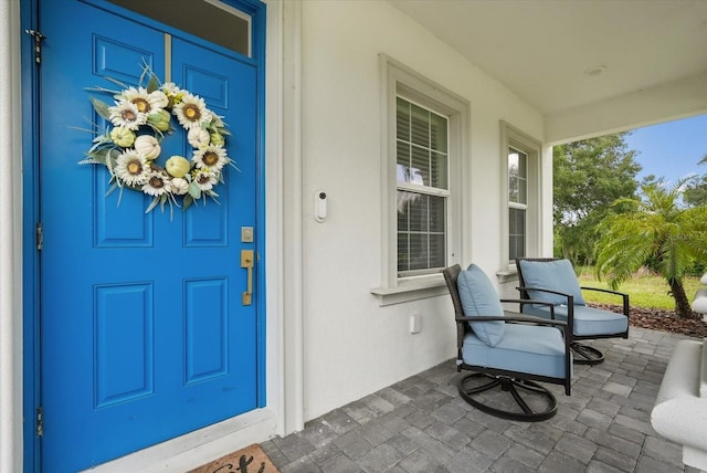8811 Bally Neal Loop, Davenport, FL 33896 - property entrance featuring covered porch and stucco siding