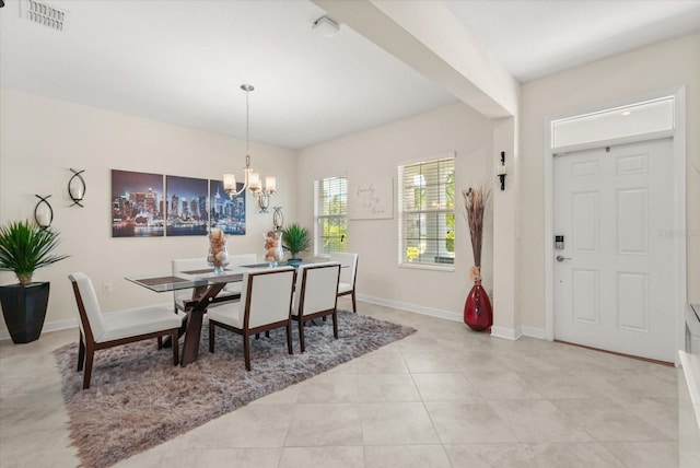 8811 Bally Neal Loop, Davenport, FL 33896 - dining room featuring a chandelier, baseboards, and light tile patterned floors