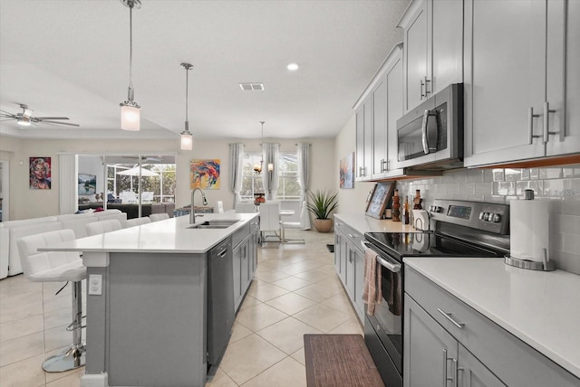 8811 Bally Neal Loop, Davenport, FL 33896 - kitchen with stainless steel appliances, a sink, gray cabinets, a ceiling fan, and recessed lighting