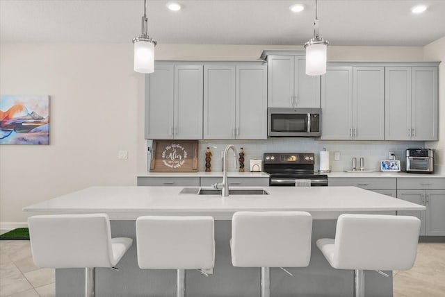 8811 Bally Neal Loop, Davenport, FL 33896 - kitchen with stainless steel appliances, a sink, decorative backsplash, light countertops, and recessed lighting