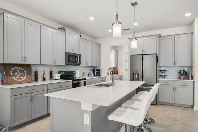 8811 Bally Neal Loop, Davenport, FL 33896 - kitchen featuring stainless steel appliances, gray cabinetry, a sink, tasteful backsplash, and recessed lighting