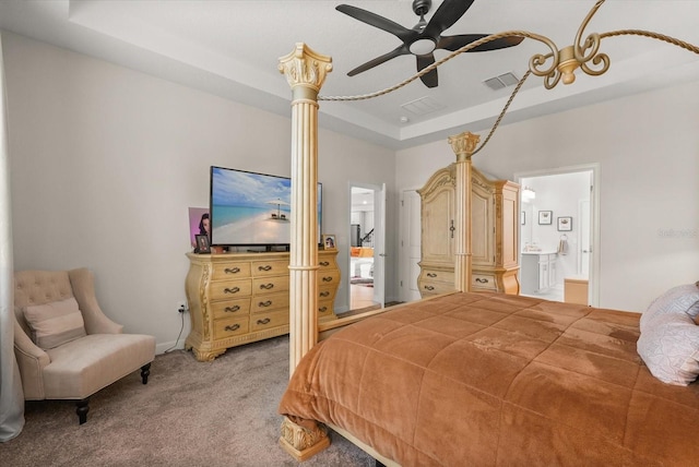 8811 Bally Neal Loop, Davenport, FL 33896 - bedroom with a raised ceiling, light carpet, ensuite bath, and a ceiling fan