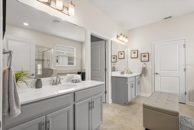 8811 Bally Neal Loop, Davenport, FL 33896 - full bathroom featuring two vanities, a stall shower, and tile patterned floors