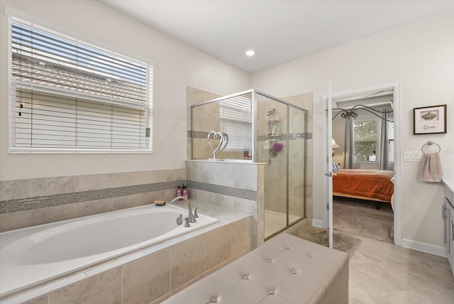 8811 Bally Neal Loop, Davenport, FL 33896 - ensuite bathroom featuring a bath, a stall shower, vanity, baseboards, and tile patterned floors