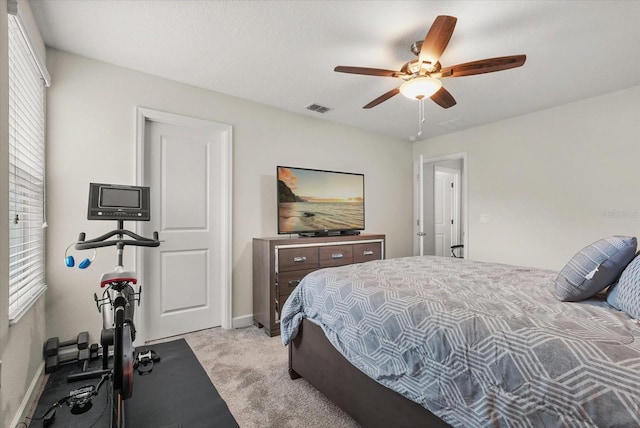 8811 Bally Neal Loop, Davenport, FL 33896 - bedroom featuring light colored carpet, ceiling fan, and baseboards