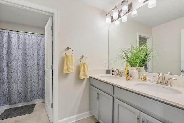 8811 Bally Neal Loop, Davenport, FL 33896 - bathroom with tile patterned flooring, double vanity, baseboards, and curtained shower
