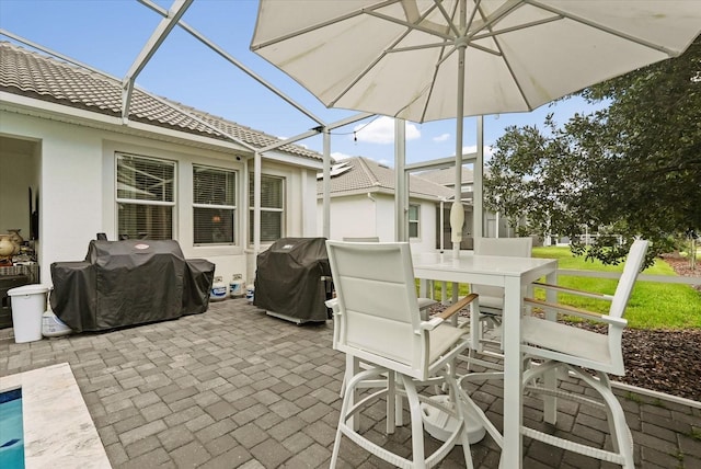 8811 Bally Neal Loop, Davenport, FL 33896 - view of patio with a grill and a lanai