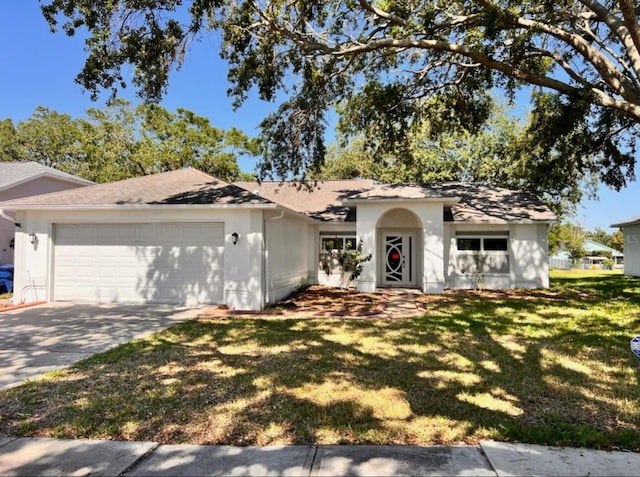 7342 Skyview Ave, New Port Richey, FL 34653 - ranch-style house with a garage, concrete driveway, a front lawn, stucco siding, and roof with shingles