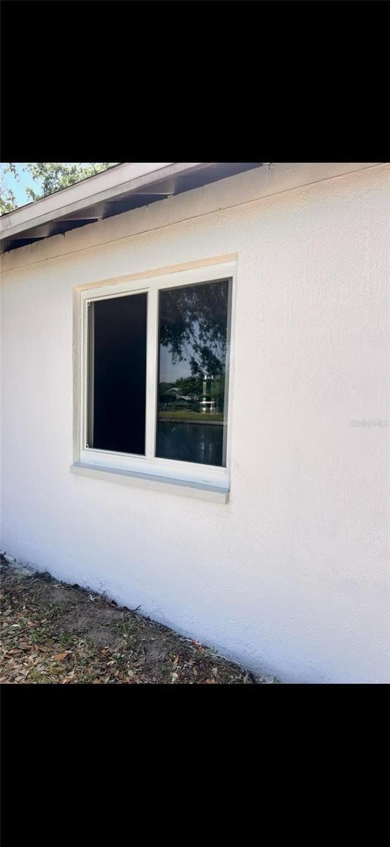 7342 Skyview Ave, New Port Richey, FL 34653 - view of side of home featuring stucco siding