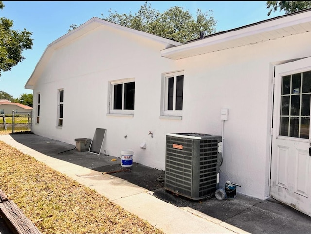 7342 Skyview Ave, New Port Richey, FL 34653 - rear view of house with central AC unit, stucco siding, and a patio