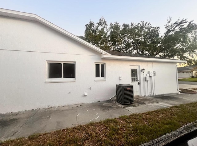 7342 Skyview Ave, New Port Richey, FL 34653 - back of house with cooling unit and a patio area
