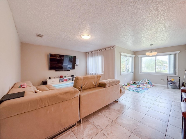 6047 Shore Line Dr, Orlando, FL 32819 - living room with a textured ceiling and light tile patterned flooring