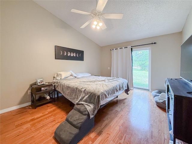 6047 Shore Line Dr, Orlando, FL 32819 - bedroom with light wood-style flooring, vaulted ceiling, a ceiling fan, a textured ceiling, and baseboards