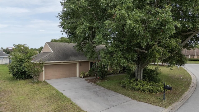6047 Shore Line Dr, Orlando, FL 32819 - view of property hidden behind natural elements with stucco siding, a front yard, driveway, and a garage