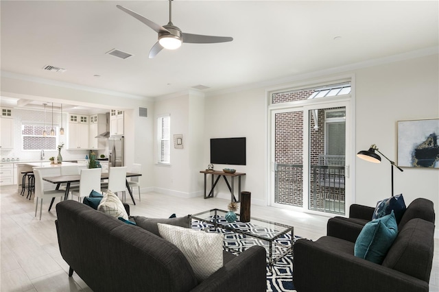 141 S Park Ave, Winter Garden, FL 34787 - living area featuring ornamental molding, ceiling fan, and light wood-style flooring
