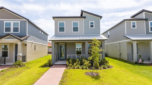 12259 Bracco St, Winter Garden, FL 34787 - view of front of home featuring a porch, a standing seam roof, a front lawn, and metal roof