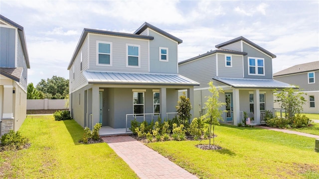 12259 Bracco St, Winter Garden, FL 34787 - view of front of house featuring covered porch, stucco siding, a standing seam roof, and metal roof
