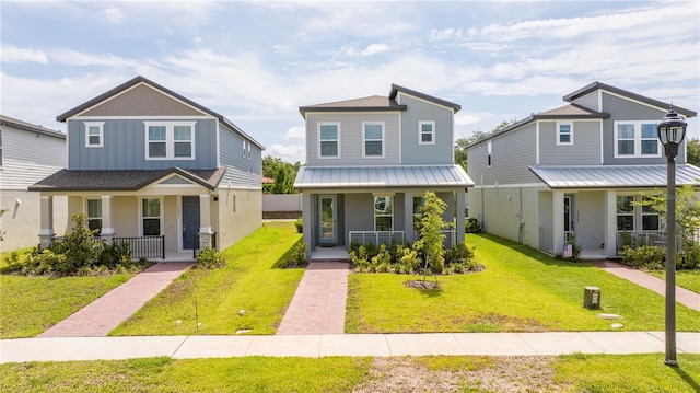 12259 Bracco St, Winter Garden, FL 34787 - view of front of house featuring covered porch, a front yard, and metal roof
