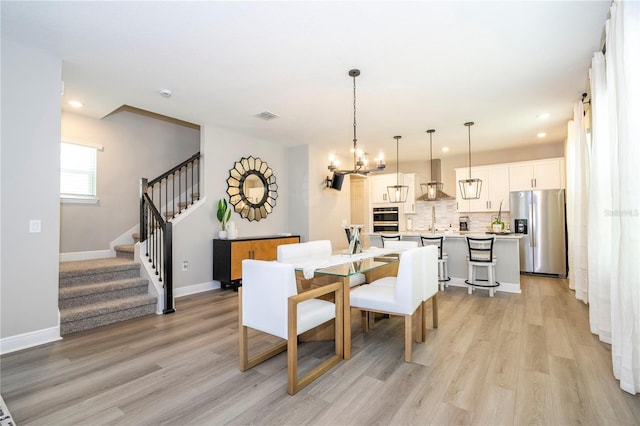 12259 Bracco St, Winter Garden, FL 34787 - dining area with a chandelier, light wood-style floors, stairs, recessed lighting, and baseboards