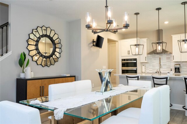 12259 Bracco St, Winter Garden, FL 34787 - dining area with a chandelier, light wood-type flooring, and recessed lighting