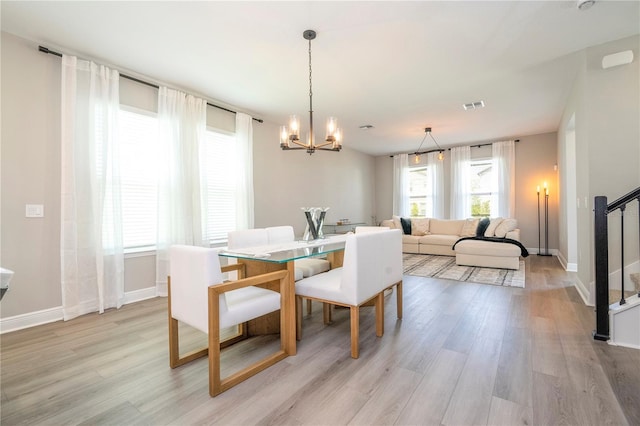 12259 Bracco St, Winter Garden, FL 34787 - dining space with light wood-style floors, a chandelier, and baseboards