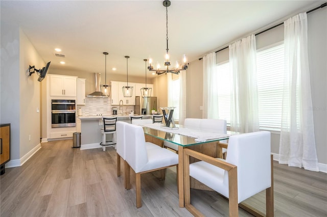 12259 Bracco St, Winter Garden, FL 34787 - dining room featuring a chandelier, light wood-style flooring, healthy amount of natural light, and recessed lighting