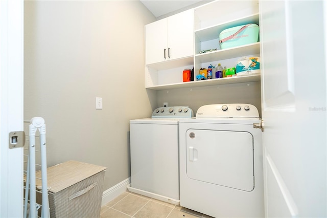 12259 Bracco St, Winter Garden, FL 34787 - laundry room featuring washer and clothes dryer, cabinet space, light tile patterned floors, and baseboards