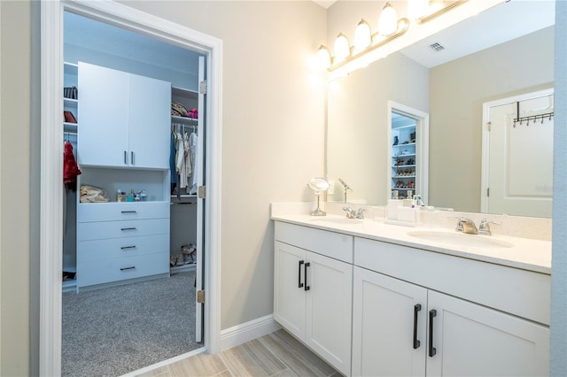 12259 Bracco St, Winter Garden, FL 34787 - bathroom featuring double vanity and a walk in closet