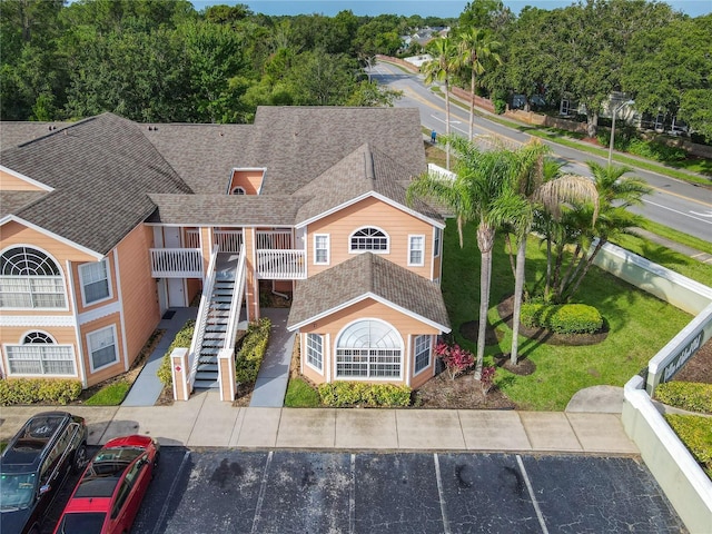 8704 Knightsbridge Ct Unit B, Kissimmee, FL 34747 - view of front of house featuring a shingled roof, uncovered parking, and stairway