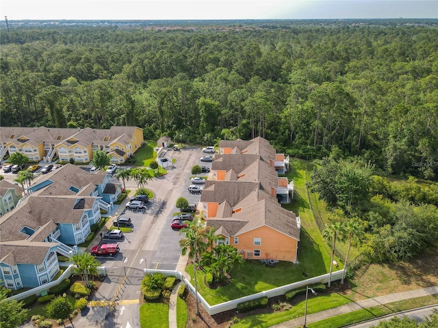 8704 Knightsbridge Ct Unit B, Kissimmee, FL 34747 - aerial perspective of suburban area with a heavily wooded area
