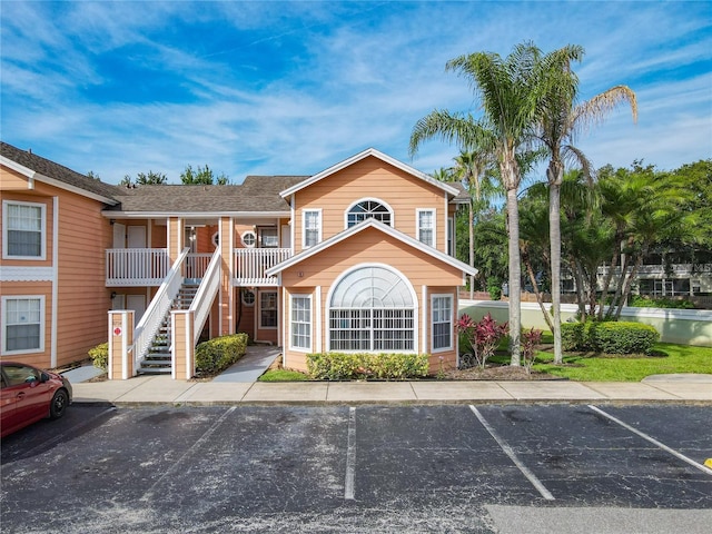 8704 Knightsbridge Ct Unit B, Kissimmee, FL 34747 - view of building exterior with uncovered parking and stairway