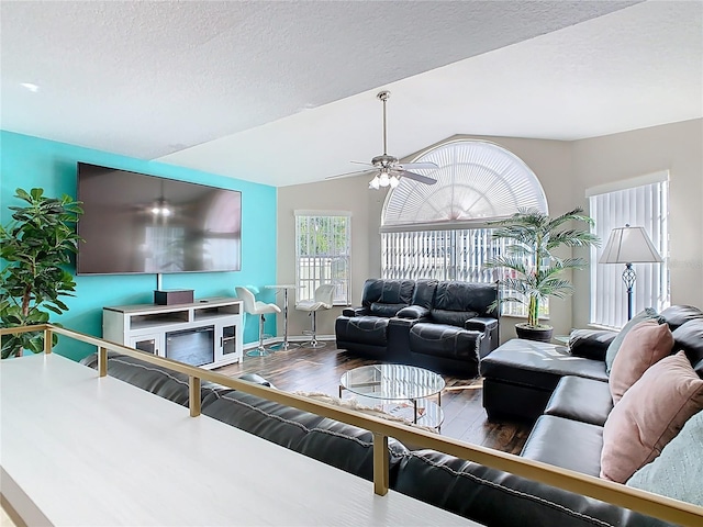 8704 Knightsbridge Ct Unit B, Kissimmee, FL 34747 - living room with wood finished floors, vaulted ceiling, a ceiling fan, and a textured ceiling