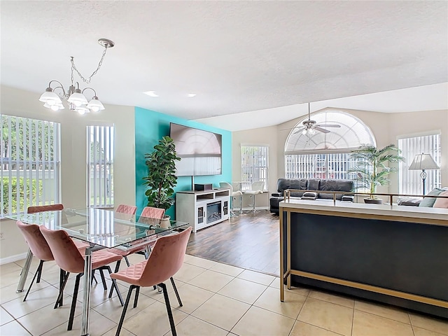 8704 Knightsbridge Ct Unit B, Kissimmee, FL 34747 - dining room featuring light tile patterned floors, a ceiling fan, baseboards, and a chandelier