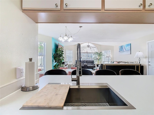 8704 Knightsbridge Ct Unit B, Kissimmee, FL 34747 - detailed view of a chandelier, a sink, and light countertops