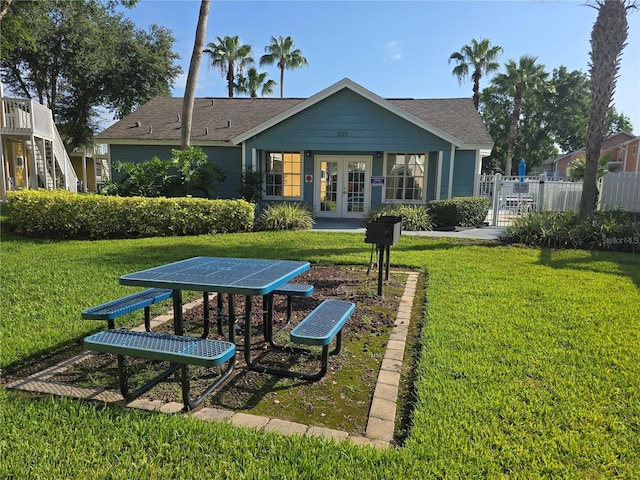 8704 Knightsbridge Ct Unit B, Kissimmee, FL 34747 - rear view of property featuring french doors and roof with shingles