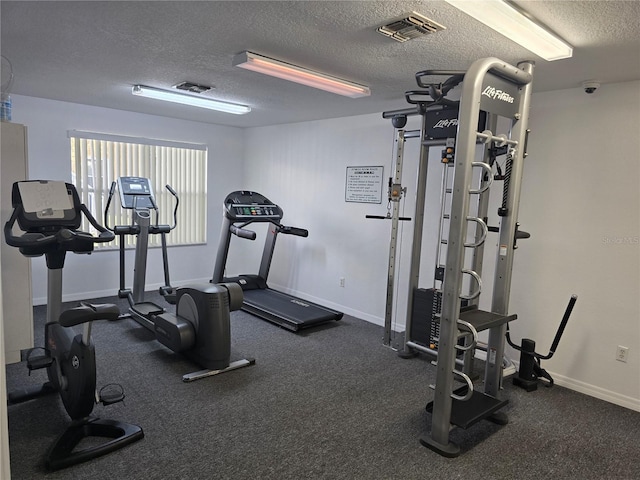 8704 Knightsbridge Ct Unit B, Kissimmee, FL 34747 - workout area with a textured ceiling and baseboards