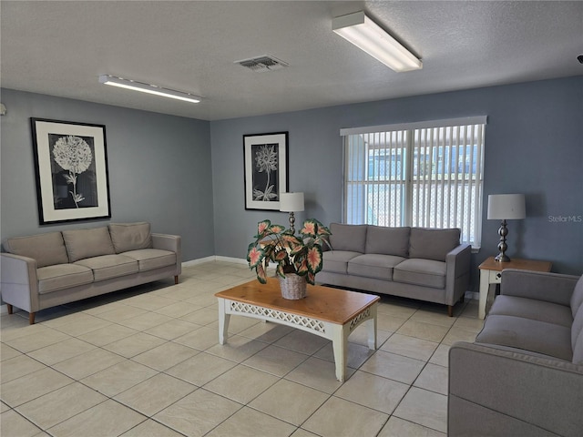 8704 Knightsbridge Ct Unit B, Kissimmee, FL 34747 - living room featuring light tile patterned floors, a textured ceiling, and baseboards