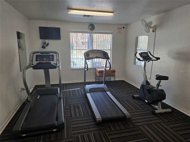 8704 Knightsbridge Ct Unit B, Kissimmee, FL 34747 - workout area with carpet, baseboards, and a textured ceiling