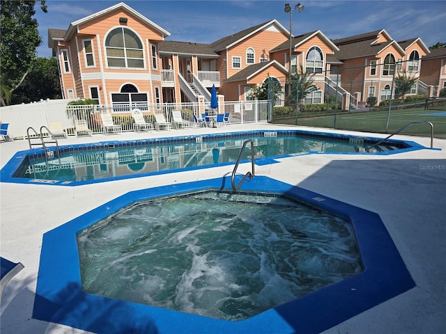 8704 Knightsbridge Ct Unit B, Kissimmee, FL 34747 - community pool with stairway, a hot tub, and a patio area