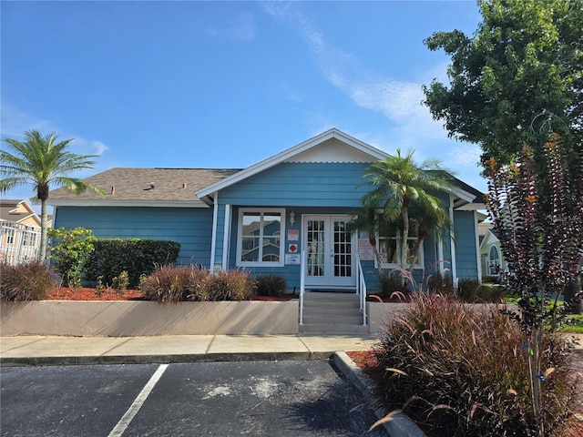 8704 Knightsbridge Ct Unit B, Kissimmee, FL 34747 - single story home with french doors, uncovered parking, and a shingled roof