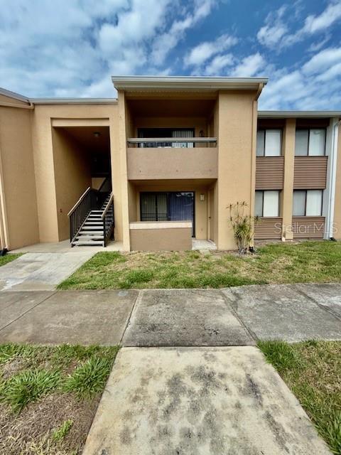 5269 Vineland Rd Unit 101, Orlando, FL 32811 - rear view of house with stucco siding