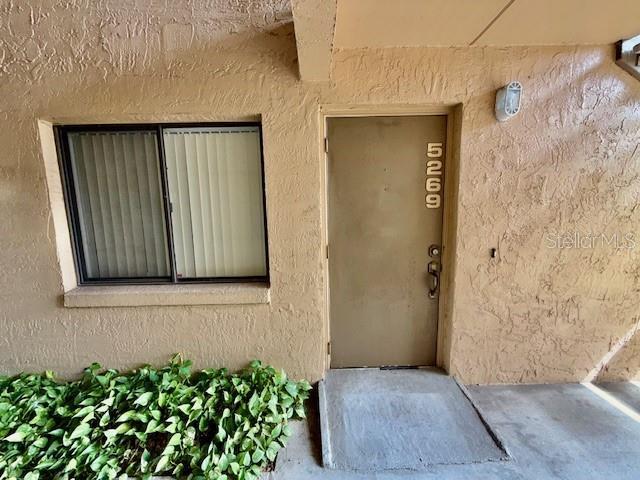 5269 Vineland Rd Unit 101, Orlando, FL 32811 - view of exterior entry featuring stucco siding