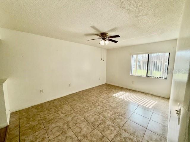 5269 Vineland Rd Unit 101, Orlando, FL 32811 - tiled spare room featuring a textured ceiling and ceiling fan
